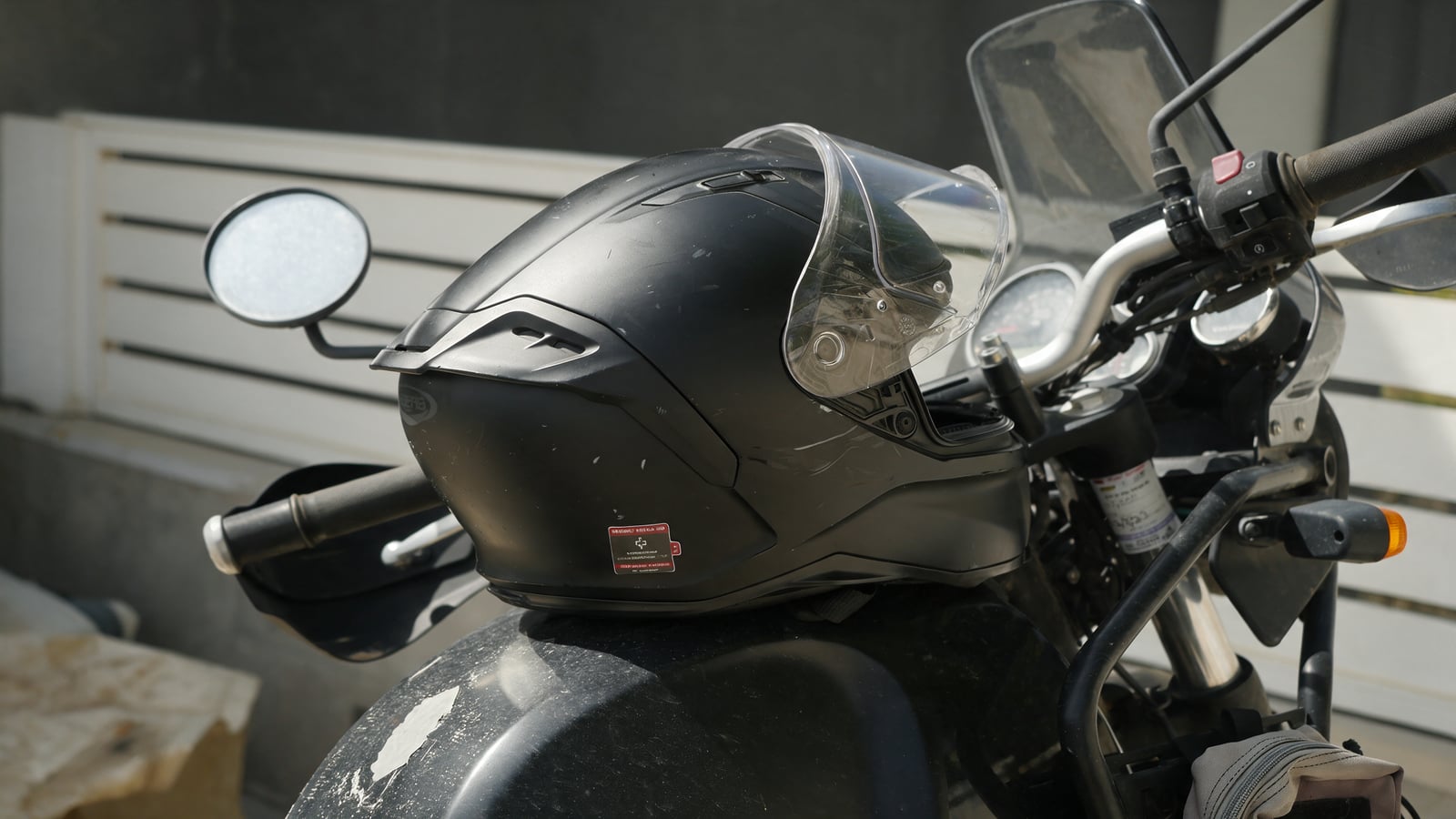 Helmet with a Vera emergency medical sticker on a motorcycle