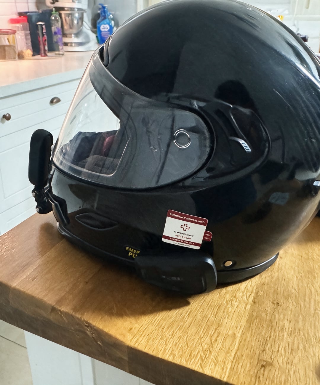 Black full-face helmet with a Vera emergency medical sticker